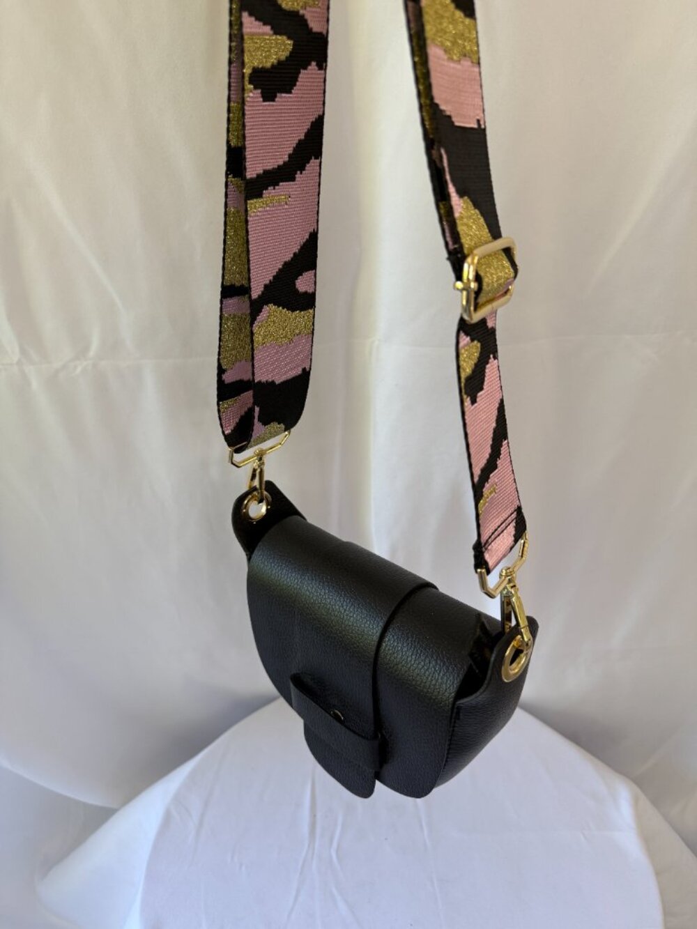 Black purse with pink and black camo strap
